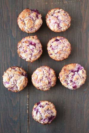 Homemade fresh and warm berries  muffins on a woodenの写真素材