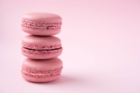 Stack of french traditional pink macarons on pinkの写真素材