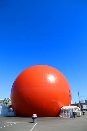 MONTREAL-CANADA, APRIL 20, 2020:   A huge orange ball named Orange Julep, a popular landmark in Montreal in Canadaのeditorial素材
