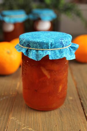 Orange and citrus homemade marmalade with blue material on topの写真素材