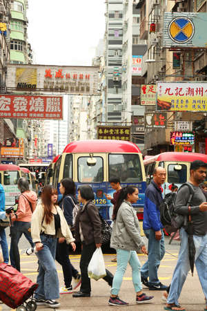 HONG KONG, CHINA - March 3, 2019:  People crossing street on a busy street. Over 90 per cent of daily trips are made on public transport, the highest percentage in the world.のeditorial素材