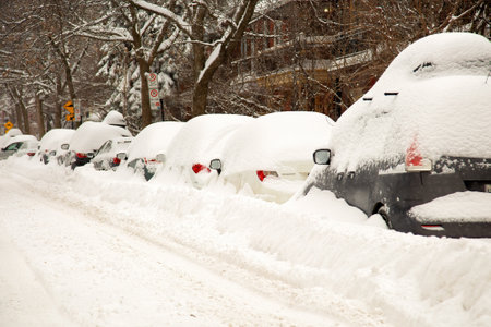 MONTREAL, CANADA, FEBRUARY 13, 2019: The street and cars are full of snow after a big snowstorm during winter season in Montreal, Quebec. More than 30 cm in 1 day on the city.の写真素材