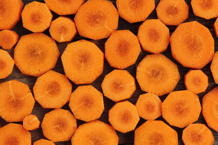 Background made with slice of carrots on a wooden tableの写真素材