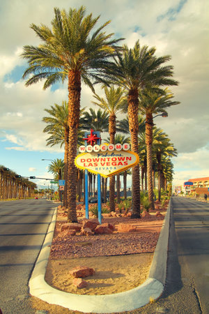 The fabulous Welcome downtown Las Vegas sign surround by palm trees and roadの写真素材