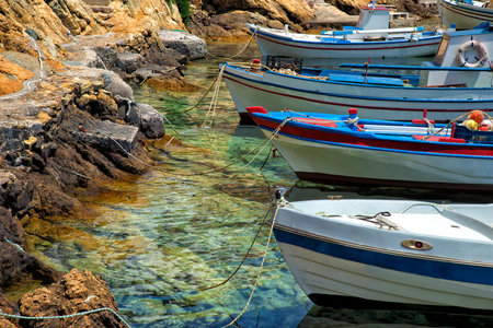 Colorful fishing boat in Greece moored along the coastline in Sifnos in Greeceの写真素材