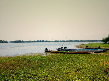 Long-tailed boats waiting for fishing beside the riverの写真素材