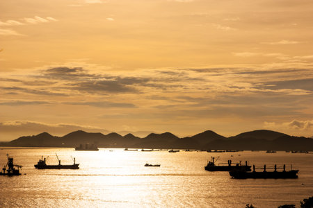 Sunset at sea with silhouettes boat fishingの写真素材