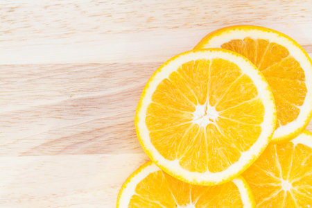 sliced of orange on wooden background 