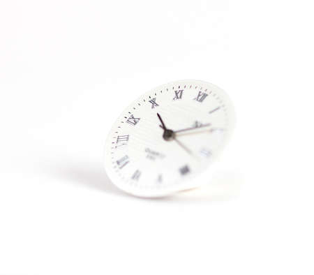selective focus on clock surface on white backgroundの写真素材