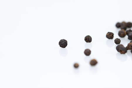 closeup dried black pepper on white background , selective  focusの写真素材