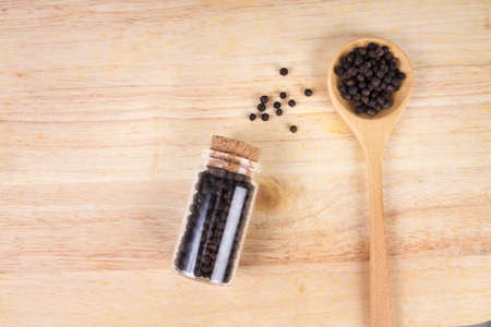 Closeup dried black pepper on the wooden plateの写真素材