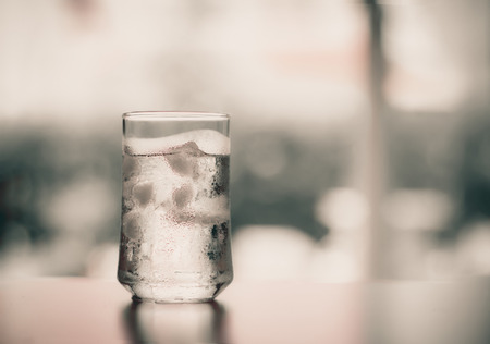 The glass of Cool fresh drink with ice cube on the  tableの写真素材