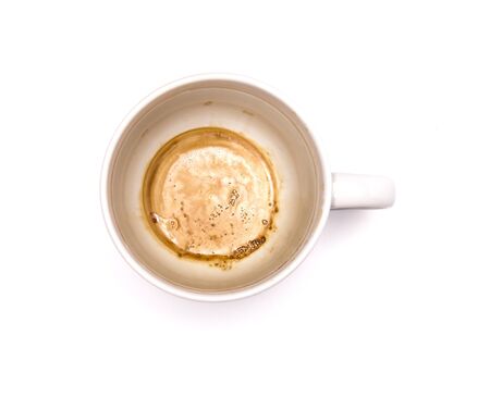 Used empty white cup of coffee with brown coffee stainedの写真素材
