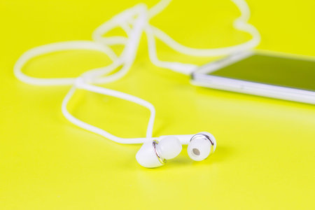 selective focus of the white earphones for using with digital music or  smart phone