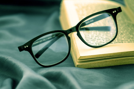 selective focus of  the reading Eyeglasses wiht opened bookの写真素材