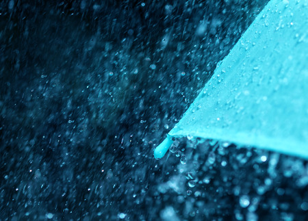 selective focus for close up a part of the umbrella which has Rain drops falling , shallow DOFの写真素材