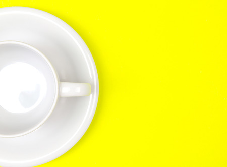 empty  the white coffee or tea cup on vibrant yellow color background with text spaceの写真素材