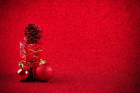 red christmas ball and gift decoration on the glitter backgroundの写真素材