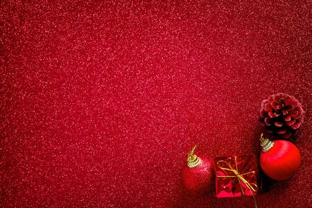 red christmas ball and gift decoration on the glitter backgroundの写真素材