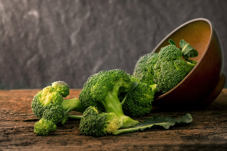 The selective focus  fresh green broccoli on wooden plate