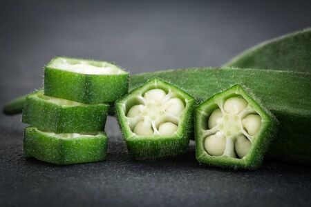 Close up  fresh okra on black stone background , still life on black conceptの写真素材