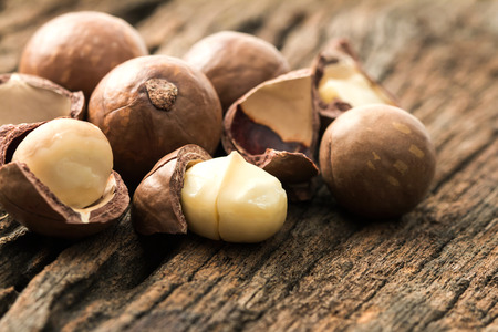 Close up the macadamia nuts on wooden plateの写真素材