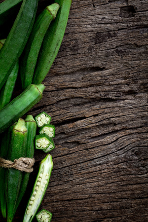 Close up the fresh okra on wooden plate , overhead shotの写真素材