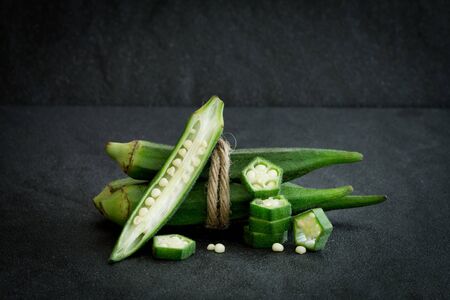 Close up  fresh okra on black stone background , still life on black conceptの写真素材