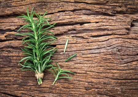 The Fresh green Rosemary bound on a wooden boardの写真素材