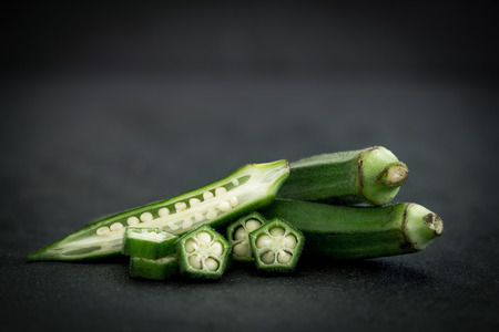 Close up  fresh okra on black stone background , still life on black conceptの写真素材