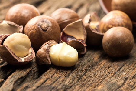Close up the macadamia nuts on wooden plateの写真素材