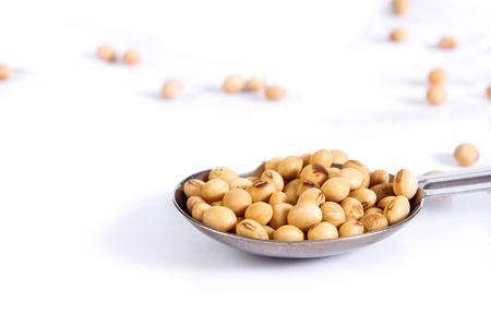 the Group of Steel measuring spoons  and soybean  on white backgroundの写真素材
