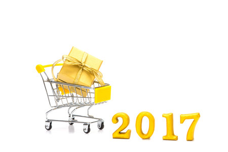 The golden gift box put in shopping cart on white background , 2017 new year celebration shopping...