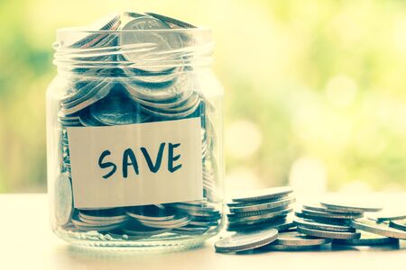 Coins in glass jar for money saving financial conceptの写真素材