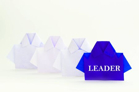 Leader word on One blue among white origami shirt paper , unique individuality and difference or leadership concept.の写真素材