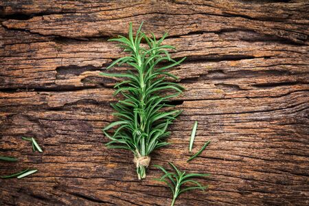The Fresh green Rosemary bound on a wooden boardの写真素材