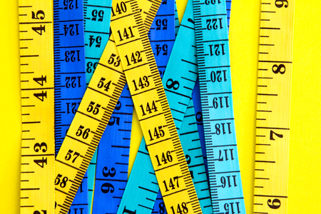 Diet control concept background. Colorful of Measuring tape on vibrant color  background. の写真素材