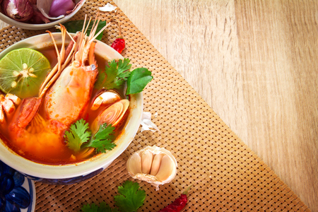 Close up Asian Spicy soup with shrimp in  bowl , famous Thai food cuisine calling Tom Yum Kung の写真素材