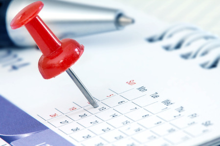 Red pushpin on calendar page for remind and marked important eventsの写真素材