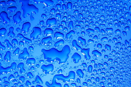 Abstract water drop on surface of  fresh blue backgroundの写真素材