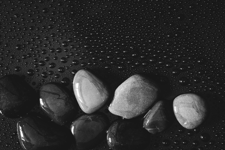 water rain drop with stones on shiny luxury black  for spa , relaxation and meditation  background conceptの写真素材