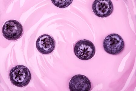 close up pink creamy homemade blueberries fruit yogurt texture backgroundの写真素材