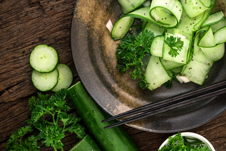 Close up cucumber salad and with chia seeds and green parsley leaf in black plate , heathy salad for anti aging with rich of antioxidant organic food conceptの写真素材