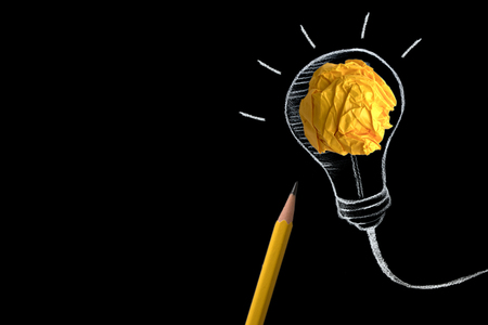 yellow pencil with yellow crumpled paper ball and hand drawn a light bulb , creative innovation idea symbol conceptの写真素材