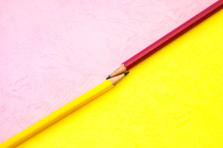 Yellow and pink  pencil on paper background ,creative innovation idea symbol or education conceptの写真素材