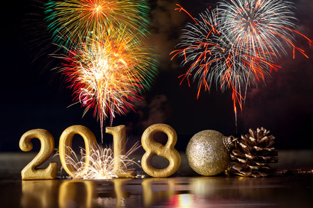 Golden Number 2018 placed on dark elegant glamour night tone background with celebration firework...