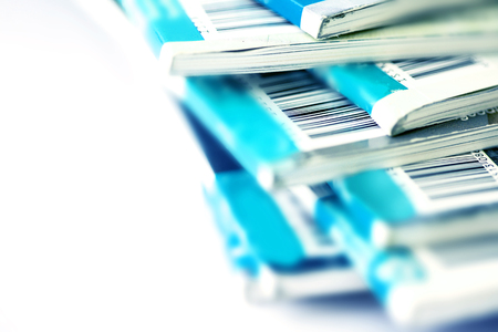 Close up part of barcode on blue magazine stacking with white background , background for copyright article conceptの写真素材