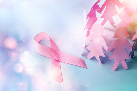 Sweet pink ribbon shape with girl paper doll on blue background  for Breast Cancer Awareness symbol to promote  in october month campaignの写真素材