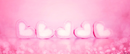 marshmallow heart shape in cup on pink background with love concept for banner designの写真素材