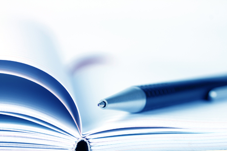 selective focus of the ball pen on opened lined diary bookの写真素材